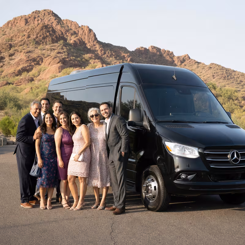 Group beside a Mercedes Sprinter limo from the Phoenix fleet