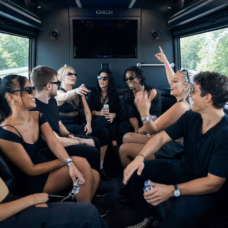 Group boarding a white charter bus for Concert Transportation transportation in Phoenix