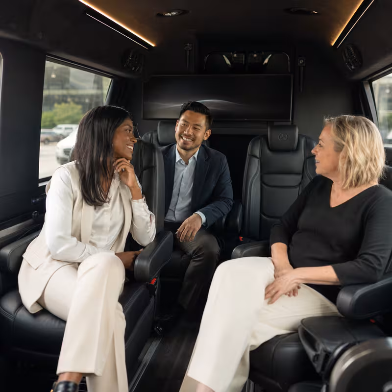 Group boarding a white charter bus for Corporate Transportation transportation in Phoenix
