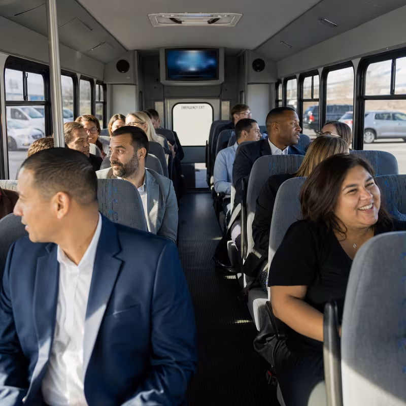 Group boarding a white charter bus for Private Event Transportation transportation in Phoenix