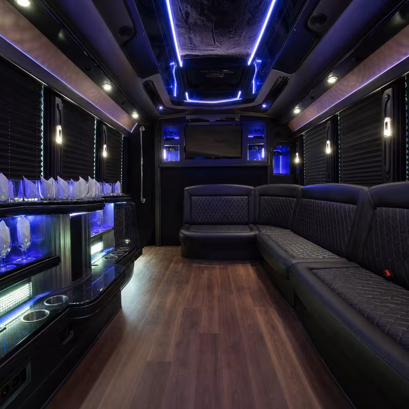 Party bus interior with wraparound leather seating and LED lighting in Phoenix