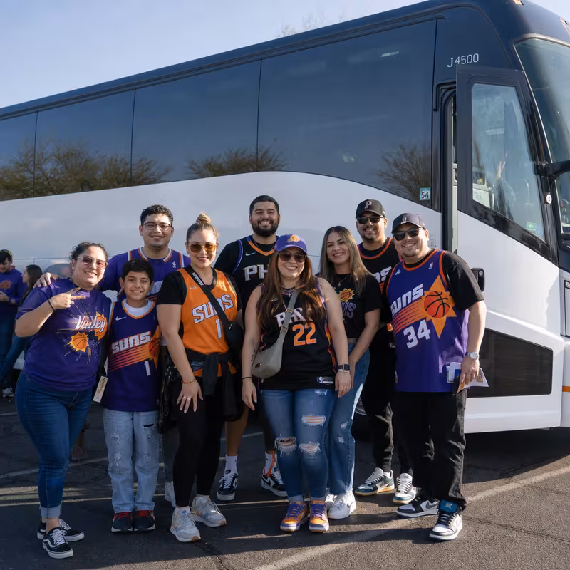 Passengers loading luggage while boarding an Phoenix group shuttle