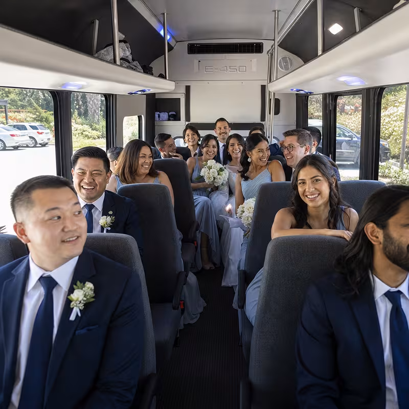 Group boarding a white charter bus for Wedding Transportation transportation in Phoenix